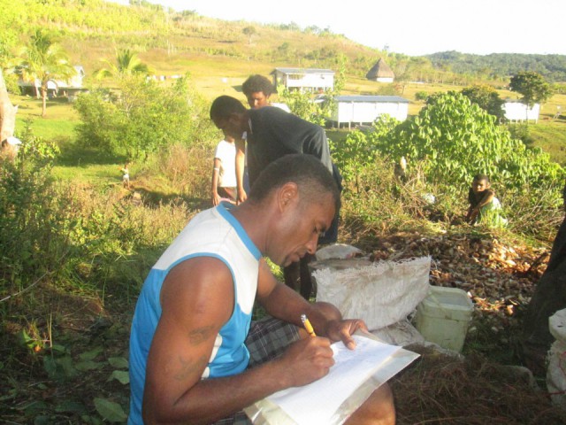 The village Chief taking notes during compost training module Fiji Highlands
